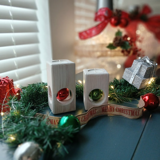 A set of two white-washed tealight holders with Christmas ornaments.
wooden tealight holders