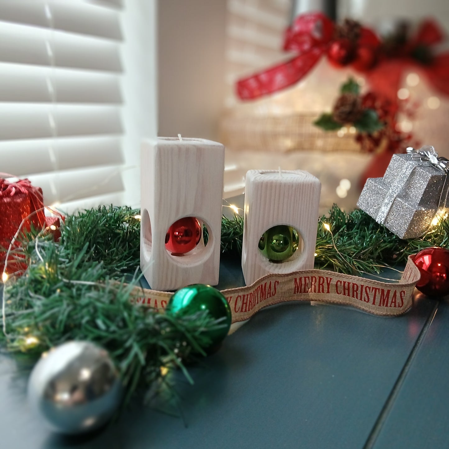 A set of two white-washed tealight holders with Christmas ornaments.
wooden tealight holders