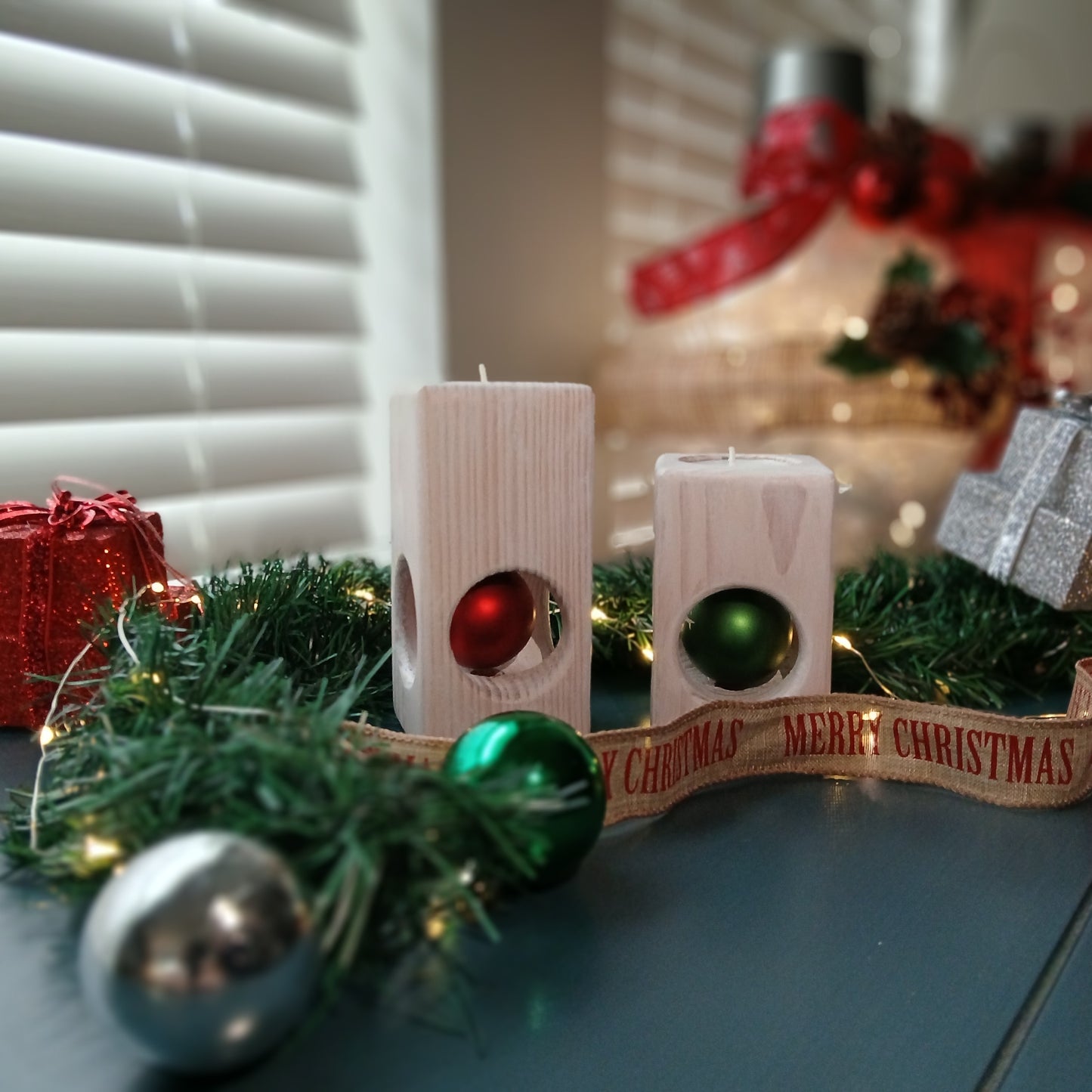 A set of two white-washed tealight holders with Christmas ornaments.
wooden tealight holders