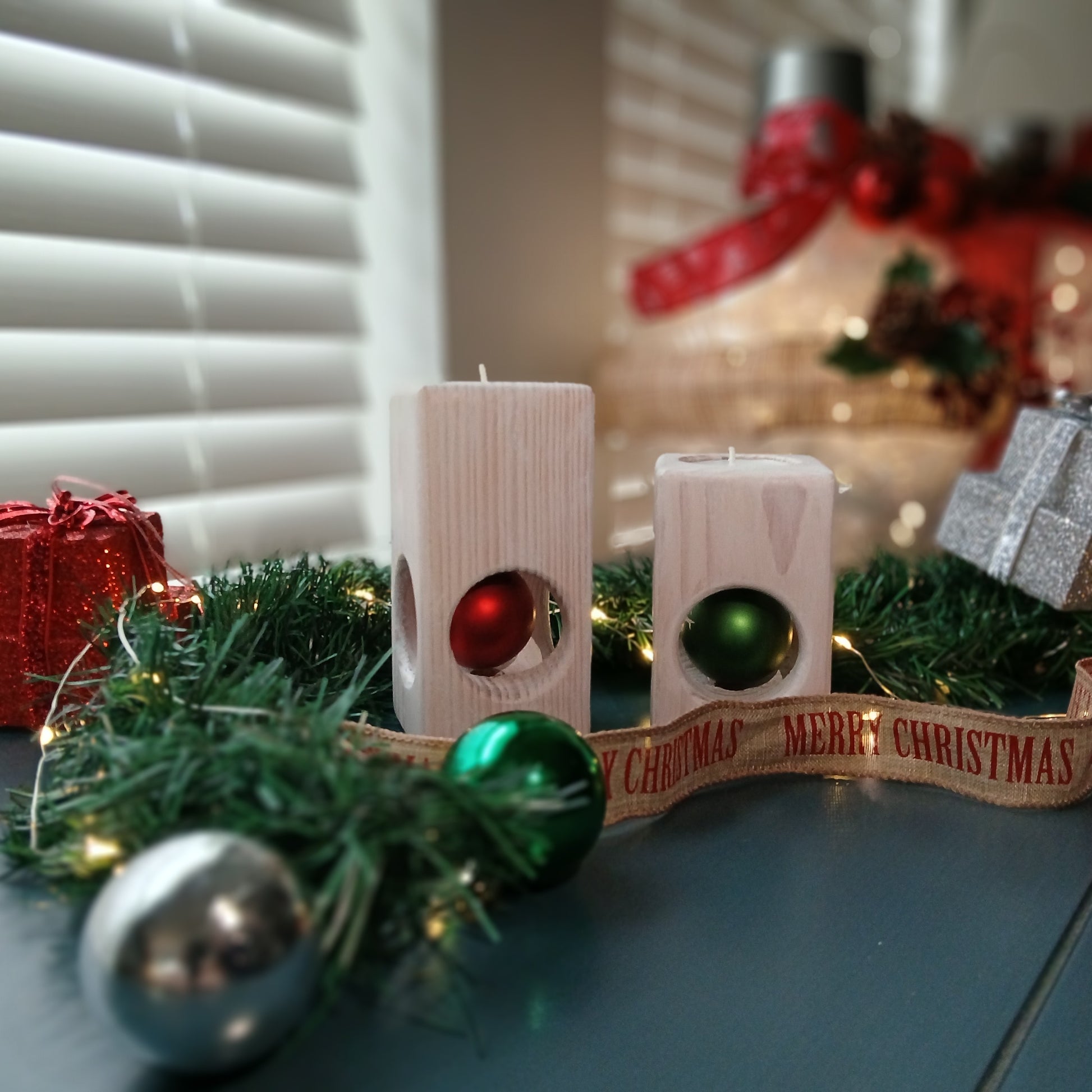 A set of two white-washed tealight holders with Christmas ornaments.
wooden tealight holders
