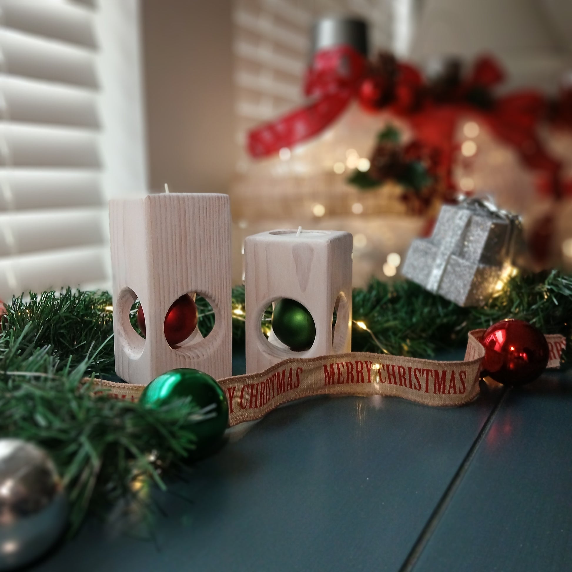 A set of two white-washed tealight holders with Christmas ornaments.
wooden tealight holders